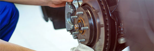 Mechanic looking at brakes on a car