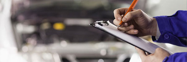 Mechanic with clipboard and pen